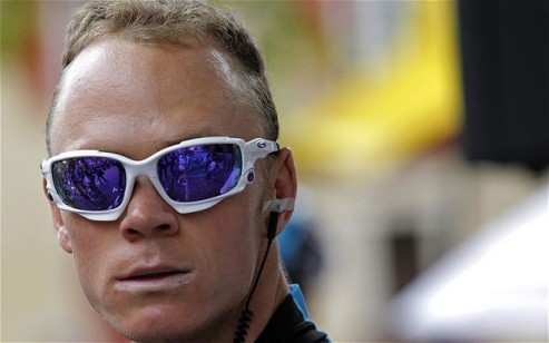 Sky's Chris Froome looks on